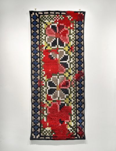 red, black, white, and yellow woven textile with floral and geometric patterns