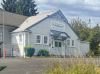 White wood paneled building with a sign that reads "Tukwila Historical Society"