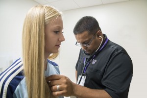 Dr. Ashwin Rao performing a heart screening on a young athlete.