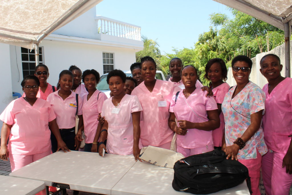 Haitian midwives wearing pink scrubs