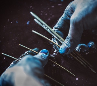 Takayuki Ishii's hands working with indigo dye