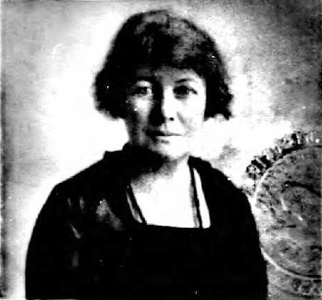 Black and white photo of a woman, showing official seal.