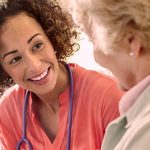 Nurse talking to older woman