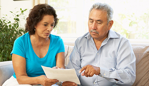 Hispanic couple looking at printed documents together