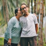 Older Asian American Pacific Islander couple hugging