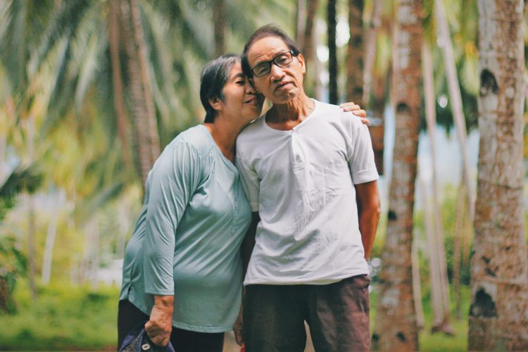 Older Asian American Pacific Islander couple hugging