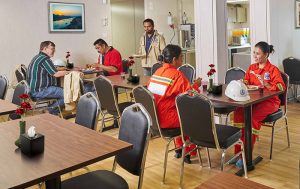 employees in a breakroom eating and talking