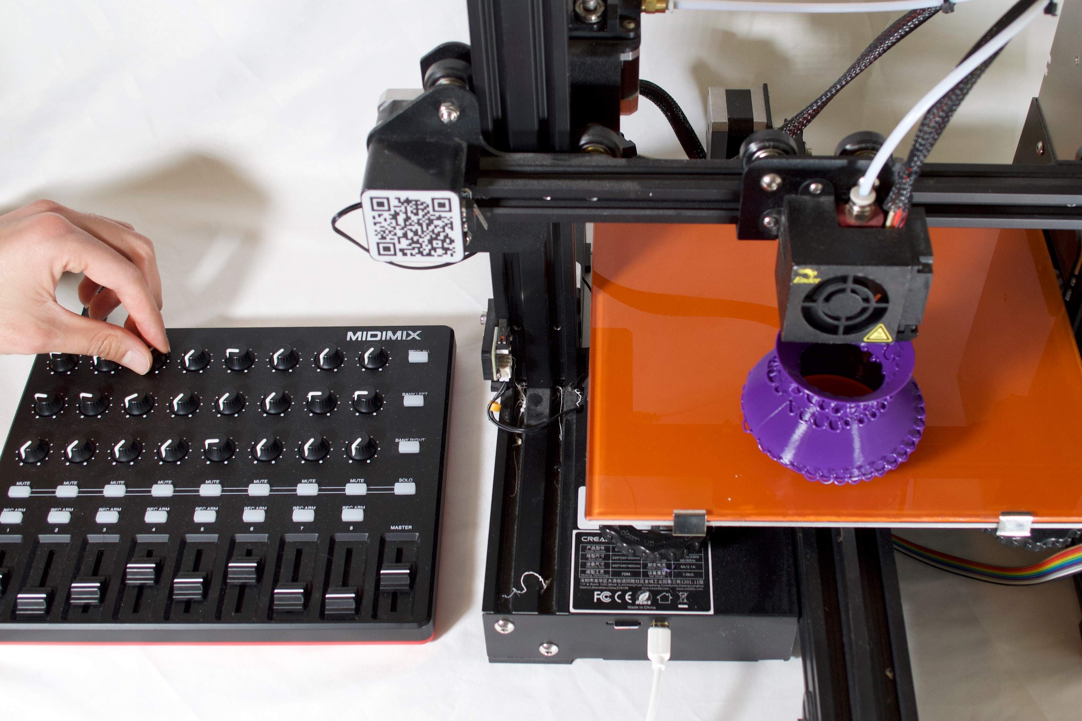 A MIDI controller connected to a 3D printer for interactive control.