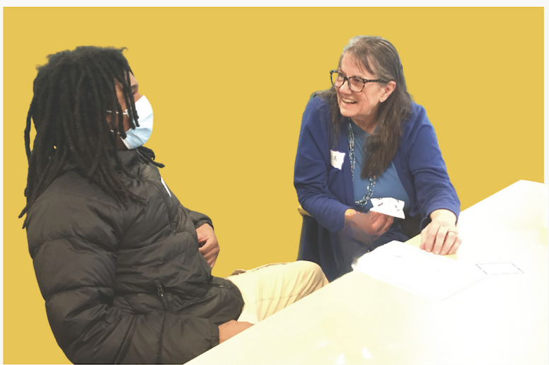 Two people talking and smiling at a table
