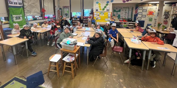 Kids in a classroom wearing brain hats