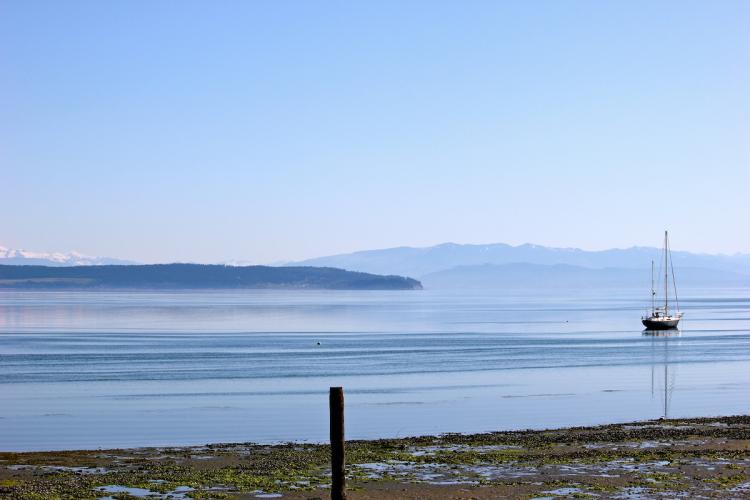 A boat on water with mountains in background