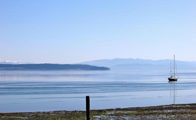 A boat on water with mountains in background