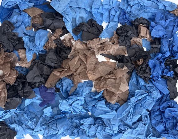 Blue, brown, and black balls of tissue paper in a design