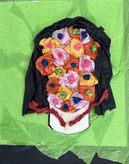 flowers fill the outline of a face with black hair