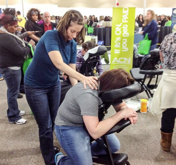 Nicole volunteers as a massage therapist at a military spouse appreciation convention.
