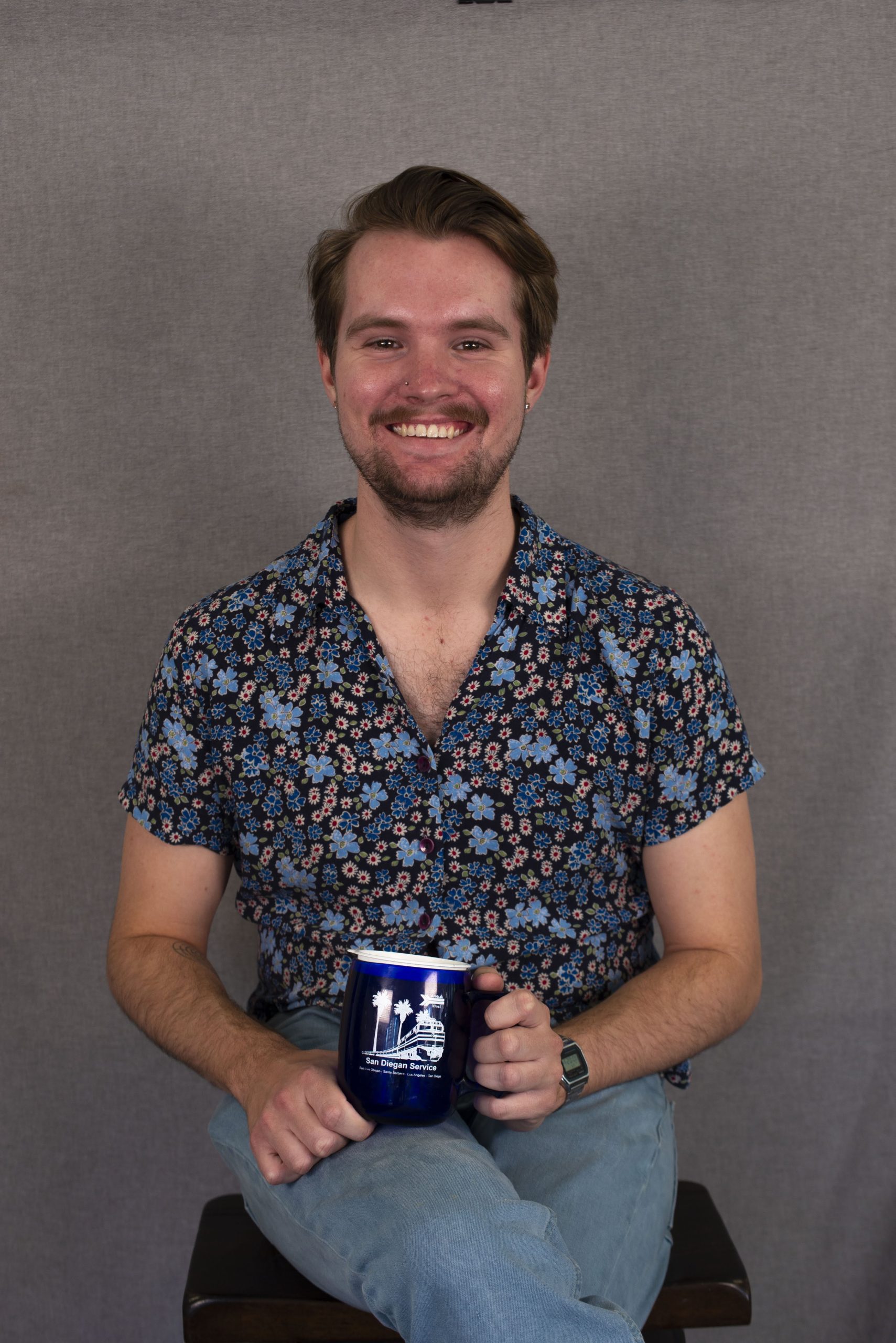 headshot of Connor holding coffee cup