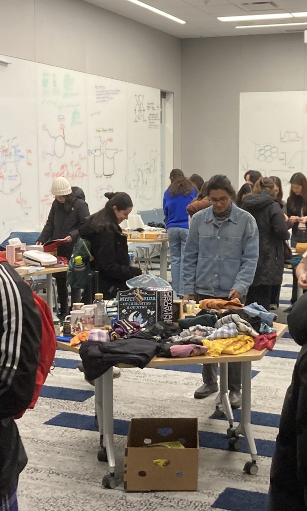 A person looks over a table of goods