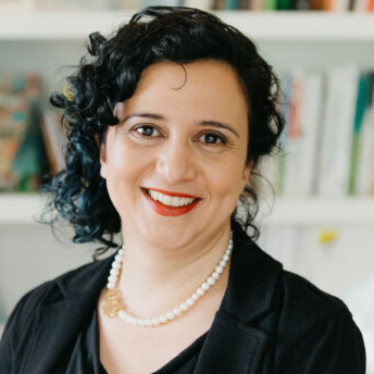 Woman with black curly hair.