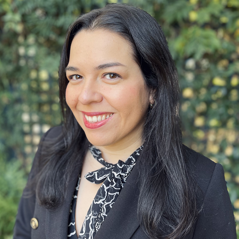 Professional woman with dark brown hair and black blazer.