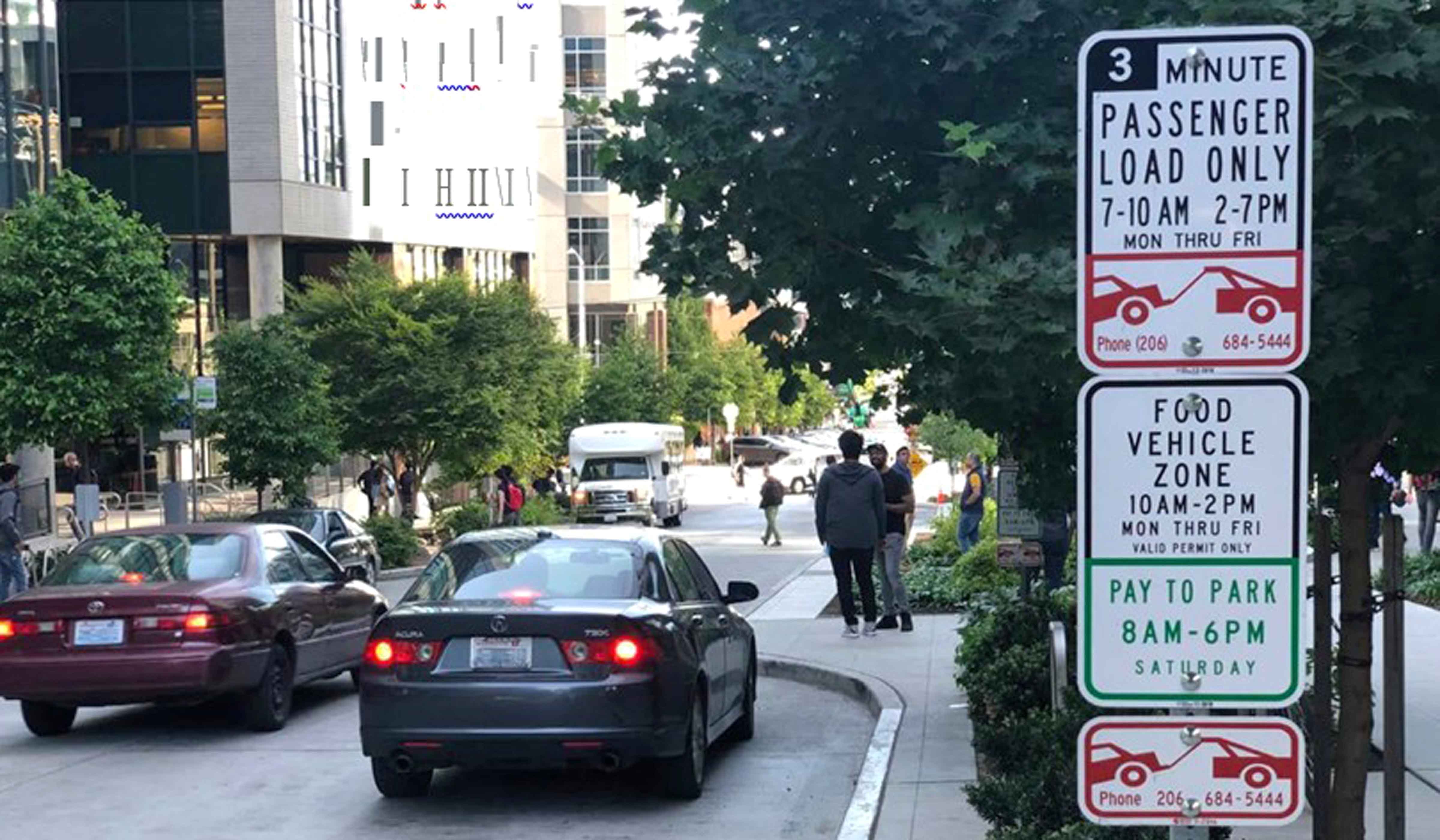 This photograph shows a loading zone in Seattle with a sign reading, "3-minute passenger load only 7 to 10 am and 2 to 7 pm Monday through Friday" and "Food vehicle zone 10 am to 2 pm Monday through Friday, valid permit only"