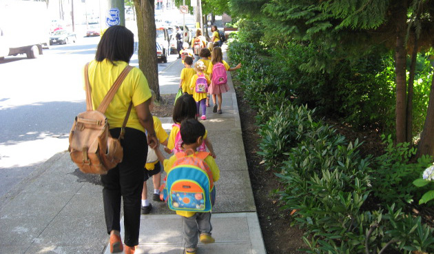 Young children walking on sidewalk