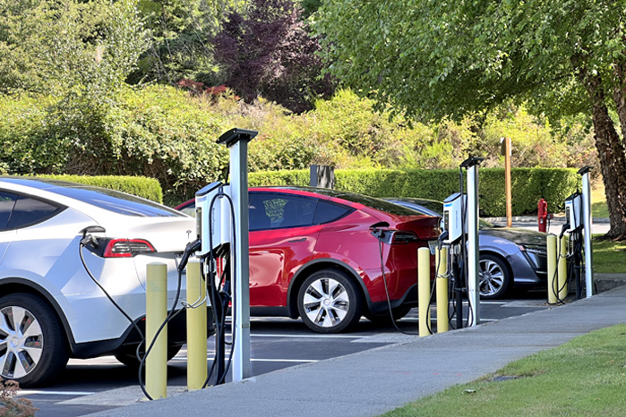 Cars at electric charging stations.