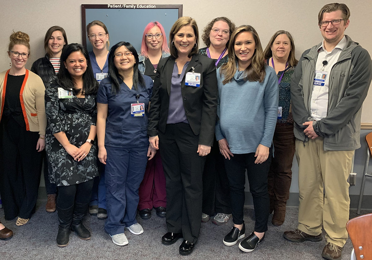 Keri Nasenbeny in group photo with nurses and staff.