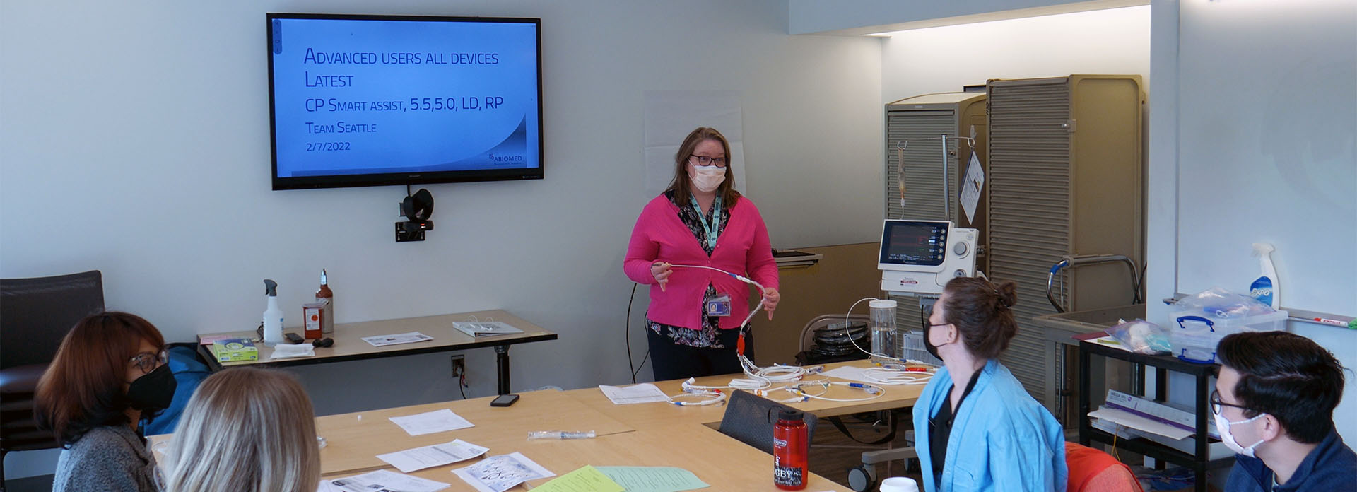 Nursing educator leading session in a small classroom. Students are masked.