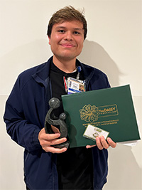 Branly Sandoval holding his award
