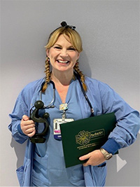 Candace Ross holding her award