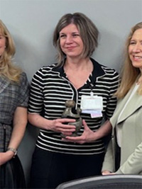 Cheri Constantino-Shor holding her award