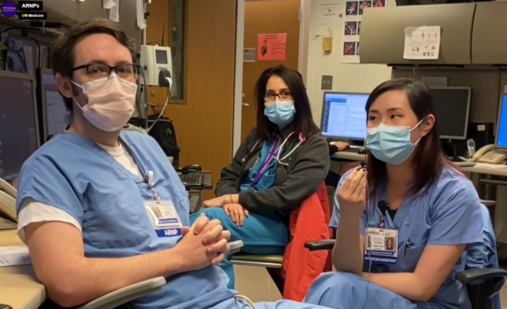 three masked nurses in a nursing station