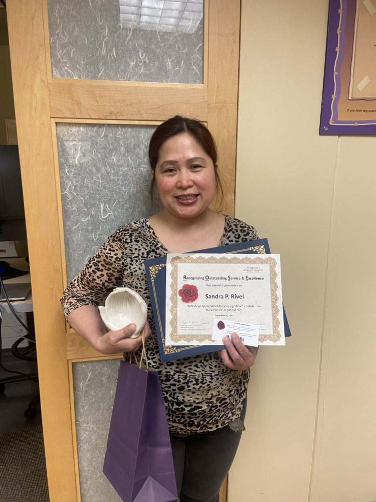 Sandra Rivel holding her award