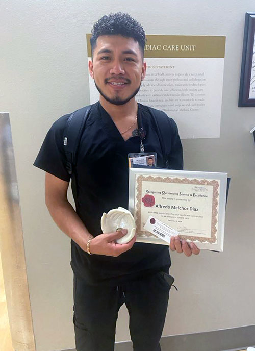 Alfredo Diaz holding his award
