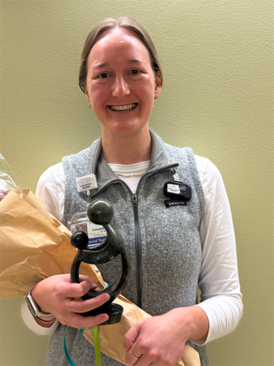 Amanda Arrington holding her award