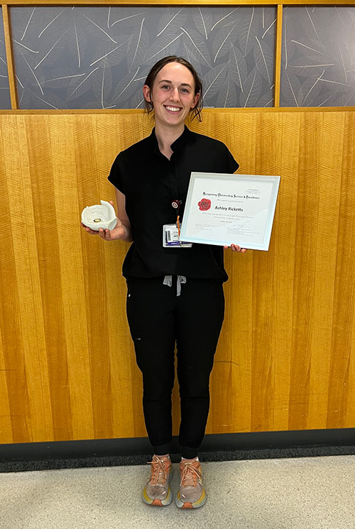 Ashley Ricketts holding her award