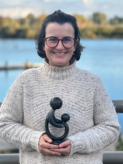 Emily Herman holding her award