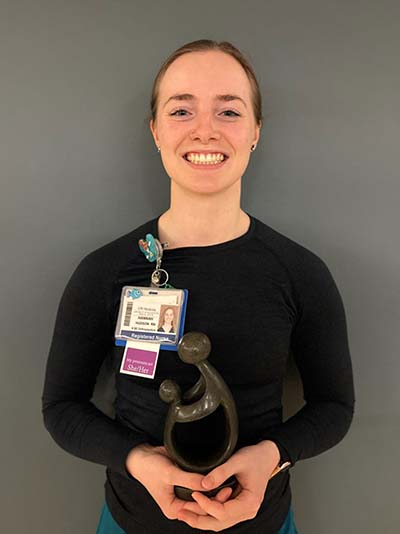 Hannah Hudson holding her award