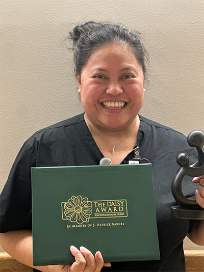 Katherine B Catapang holding her award