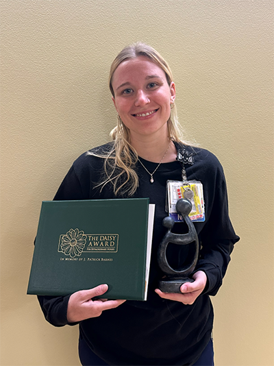 Katherine Bull holding her award