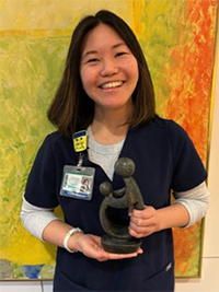 Lora Tseng holding her award