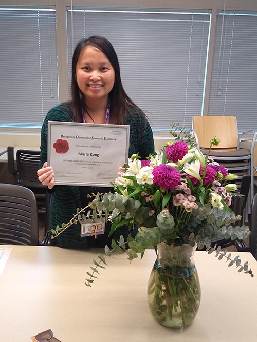 Marie Kong holding her award