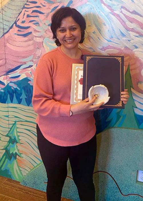 Navroop Whillon holding her award