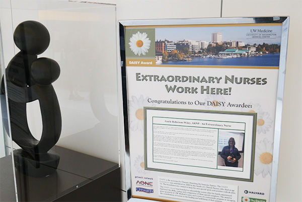a daisy award near a sign that says extraordinary nurses work here