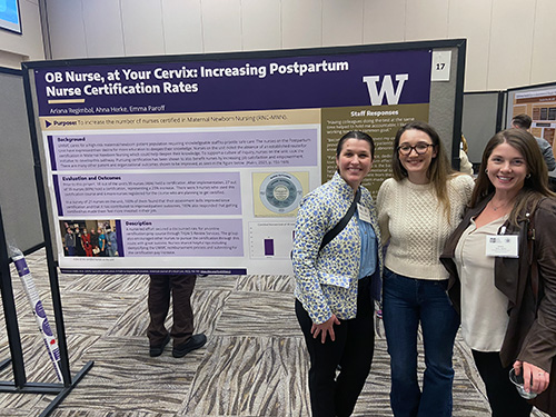 Photo of poster presenters standing near poster titled OB Nurse, at your cervix: Increasing Postpartum Nurse Certification Rates