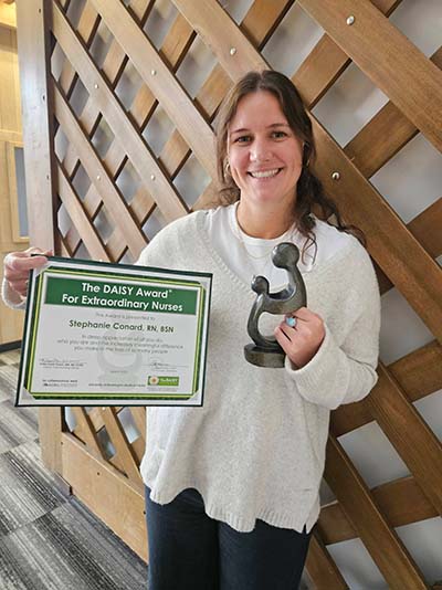Stephanie Conard holding her award