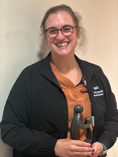 Alexandra Bouchard holding her DAISY award.