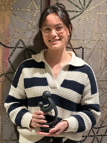 Christina Garrison holding her DAISY award.