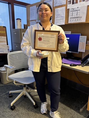 Jerusa Salas holding her ROSE award.