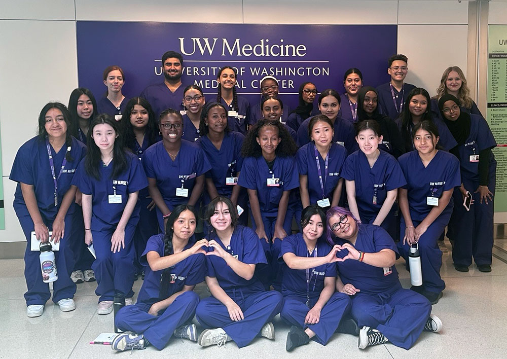 Nurse camp attendees gathered for a group photo in a hospital corridor.